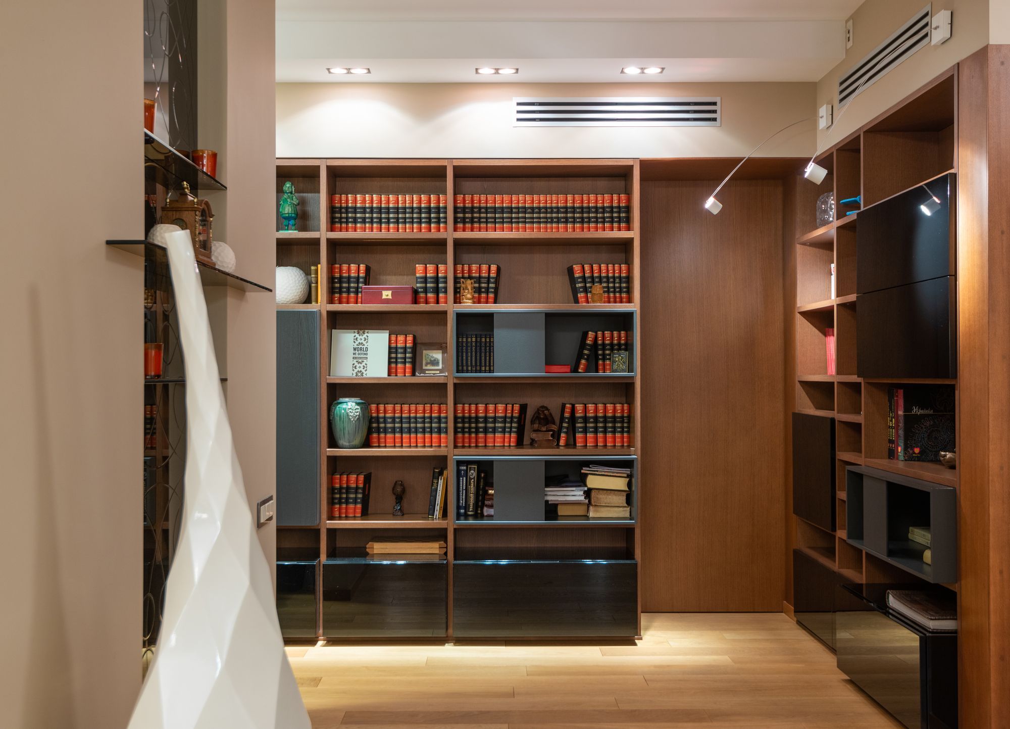 Floor-to-ceiling built-in timber shelving in a living room